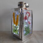 A fused glass floral lantern A fused glass floral lantern