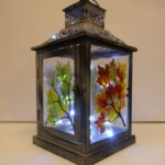 A lantern with leaves in the 4 seasons Lantern with fused glass panels